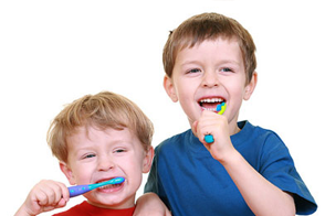 Children with toothbrushes in their mouths